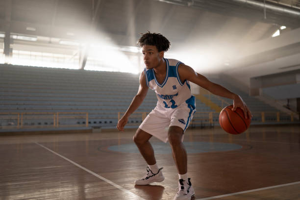 istock Young man dribbling basketball 1629138442