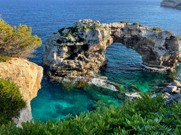 istock Es Pontas is a natural stone arch or bridge on Majorca, Spain 1629139000