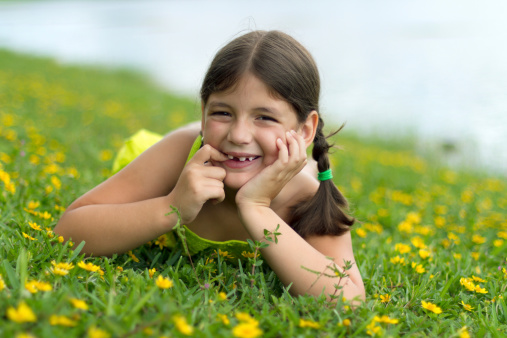 Hispanic girl smiling on grass