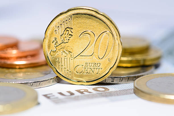 20 cent euro coin with euro coins and bills in background stock photo