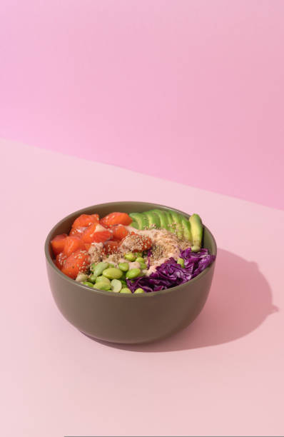 istock poke bowl with salmon on pink background 1629150614