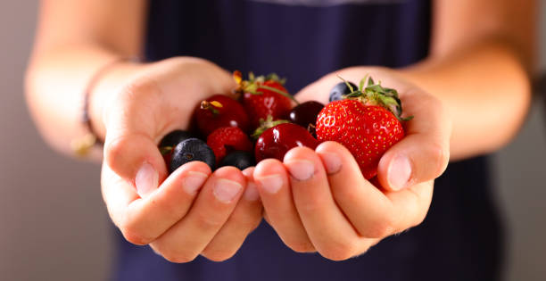 istock close up on hand holding berries fruits 1629172195