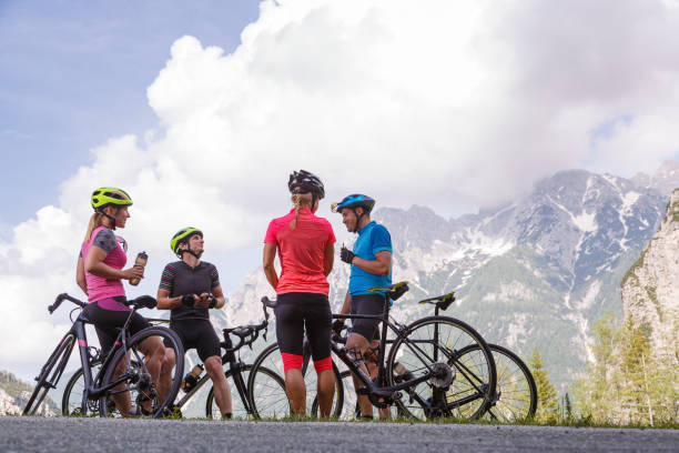 Cycling group resting on a mountain pass stock photo