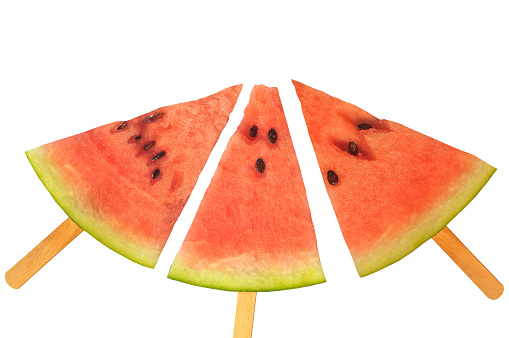 Slices of watermelon on an ice cream sticks-concept, on a white background