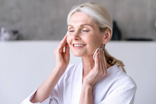 istock Mid age woman using cotton pad for cleaning face 1629183423