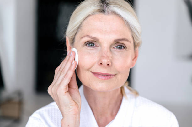 istock Removing makeup with micellar water and cotton pad disks. 1629183440