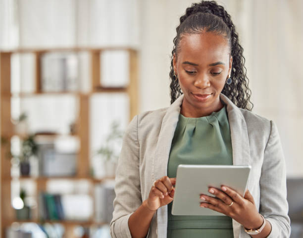 istock Black woman, tablet and planning in office for business information, data analysis or internet research. Female employee working on digital technology for online connection, website and scroll on app 1629184510