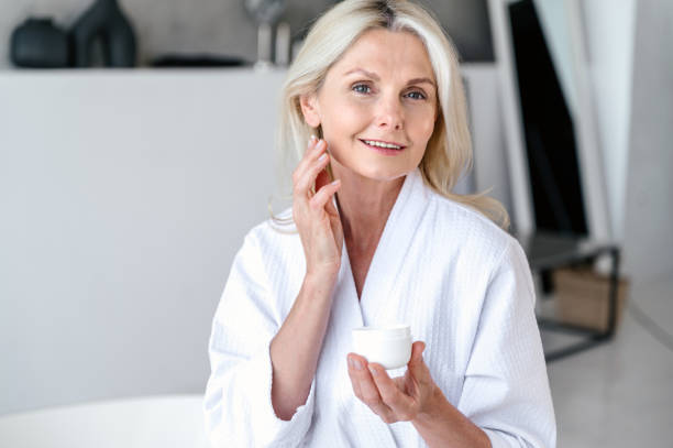 istock Everyday morning routine of apllying anti aging cream on face 1629184511