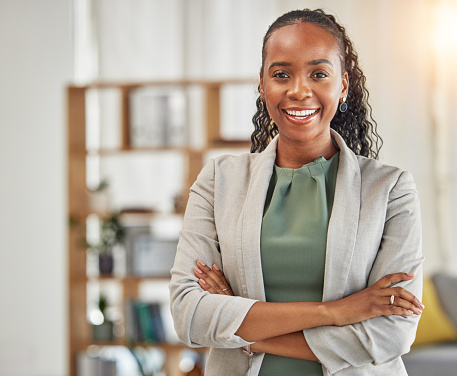 Portrait, black woman and smile with arms crossed in office for confidence, corporate pride and professional lawyer in Nigeria. Happy african female advocate working in company, law firm and business