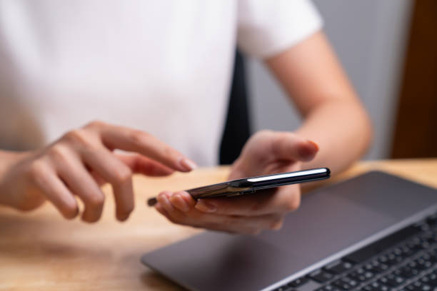 istock Woman holding black smartphone and chatting online message on mobile. 1629194712