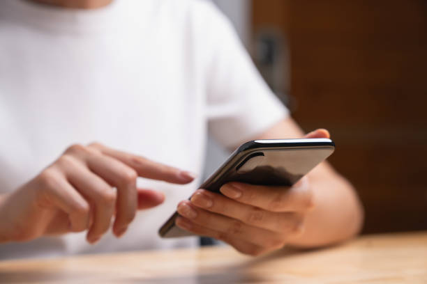 istock Woman holding black smartphone and chatting online message on mobile. 1629194718