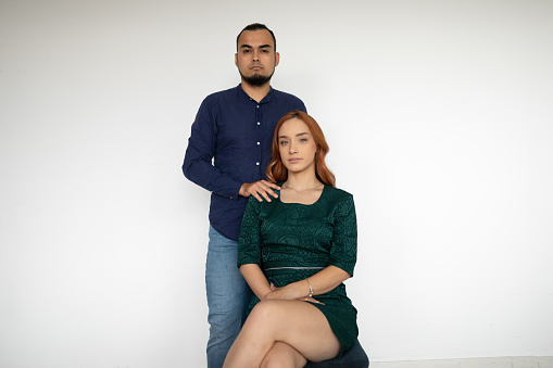 Portrait of a mid adult Hispanic man and Caucasian woman in an apartment