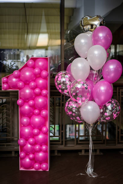istock Decorated number 1 with pink balloons for a birthday. 1629248174