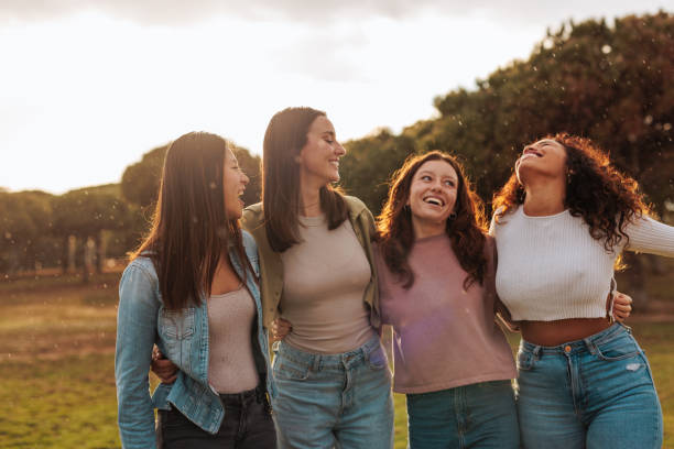 istock Four friends enjoying walking in the field 1629260871