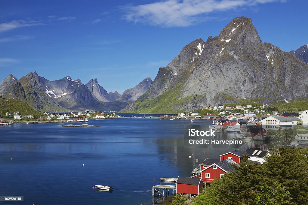 Reine in Norway Scenic town of Reine, Norway on sunny summer day with picturesque fjord and surrounding mountain peaks Norway Stock Photo