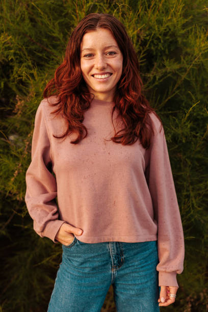 istock Girl with red hear posing, smiling and looking at the camera 1629262030