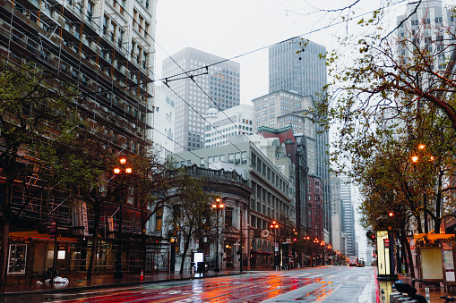 Dramatic View of modern building exterior of central district of San Francisco city during foggy mist morning, the United States