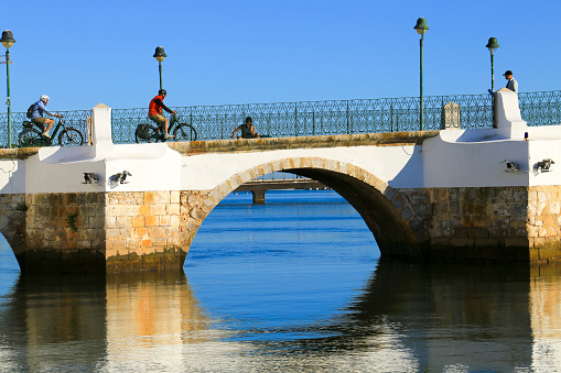 Tavira, Portugal- October 20, 2022: The stone Bridge Ponte Romana in the old town of Tavira, Portugal