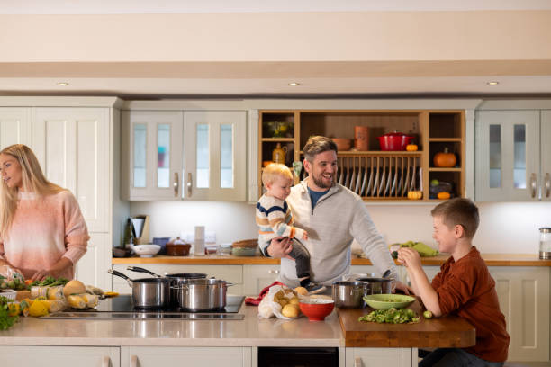 istock Family with Two Children Preparing Dinner 1629268568