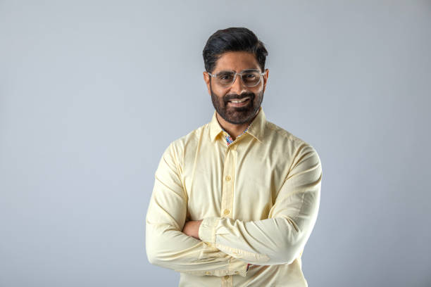 istock Confident businessman with arms crossed over white background 1629280902