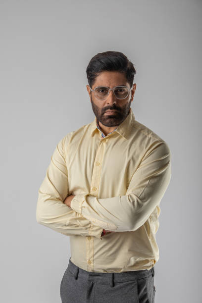 istock Confident businessman with arms crossed over white background 1629281407