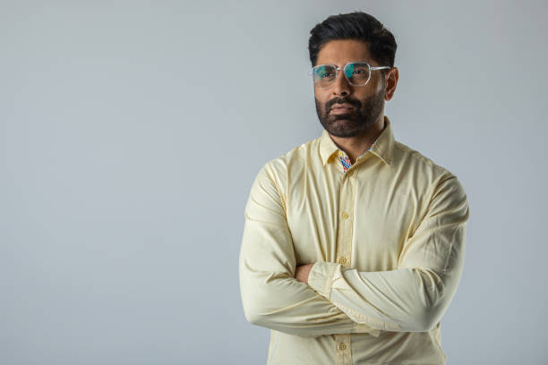 Confident businessman with arms crossed over white background
