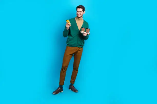Full length body photo of young worker man elegant garment browsing phone free coffee mcdonalds advert isolated on blue color background.