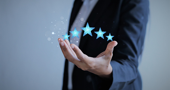 Five Stars Rating floating on Hand businesswoman. feedback survey concept. Customer review, satisfaction, customer Experiences.