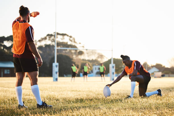 istock Rugby, sun and sport game with support, exercise and competition with athlete ball training. Field, back and target practice on grass with cardio, fitness and team workout outdoor for teamwork 1629288445