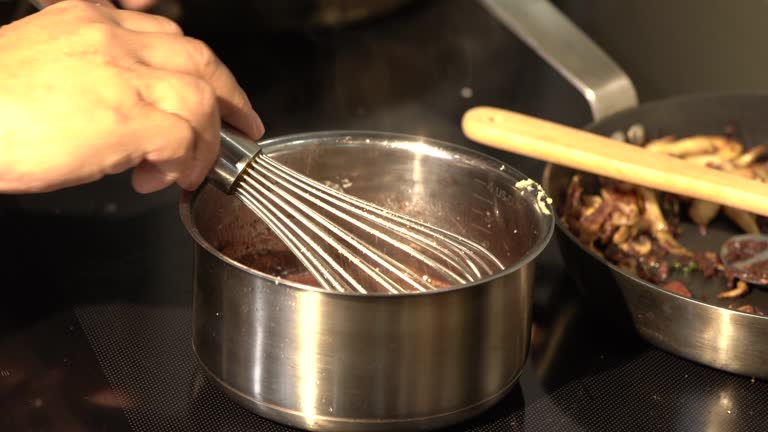 Cooking raw pork in an aluminum pot with boiling soup stock on an electric stove is a safe and common way to prepare the meat.