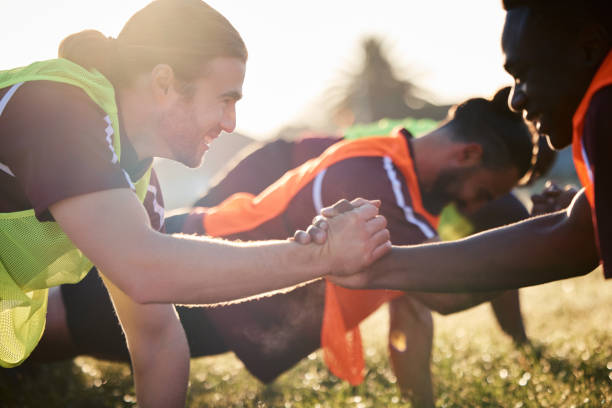 istock Rugby, handshake and team, exercise and training, cooperation and sunrise. Shaking hands, sports partnership and happy athlete group in agreement, solidarity and workout, fitness and collaboration. 1629303044
