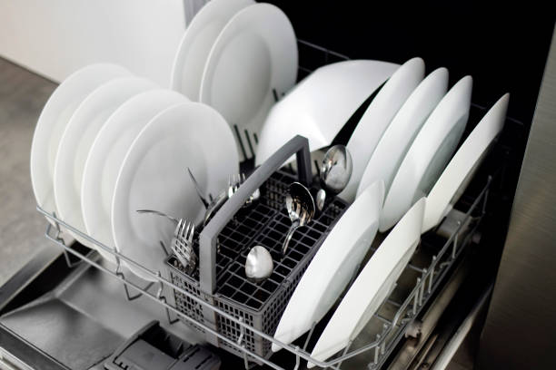 istock Built-in dishwasher. Clean dishes in the dishwasher. A clean white utensil. Modern technologies in the kitchen. Modern home kitchen. Housework 1629318992