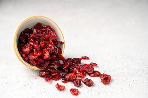 Dry cranberries. Dehydrated red berry snack in a bowl.
