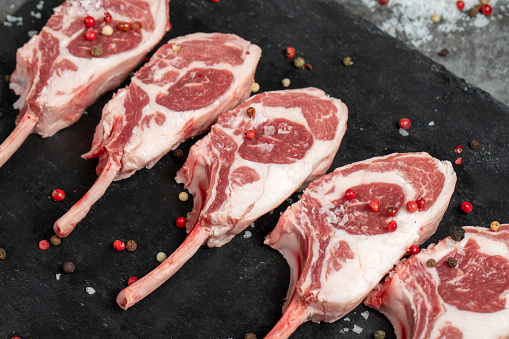 Lamb chops. Fresh raw lamb chops on dark background. Butcher products. Close up