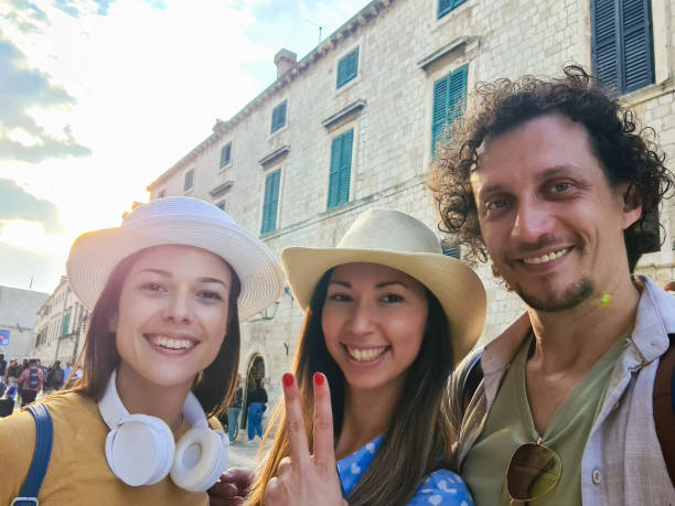 istock Three Young Friends Taking Selfies On The Town Square In Dubrovnik 1629332597