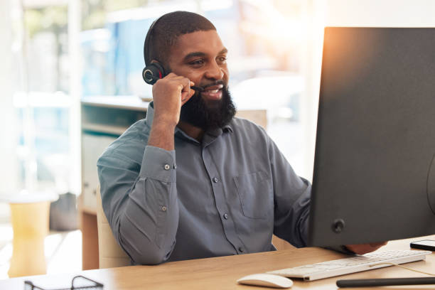 istock Man, computer and call center for communication, happy sales advisor and customer support in e commerce. Agency worker, telecom and african person with virtual chat, helping or web contact on desktop 1629333193