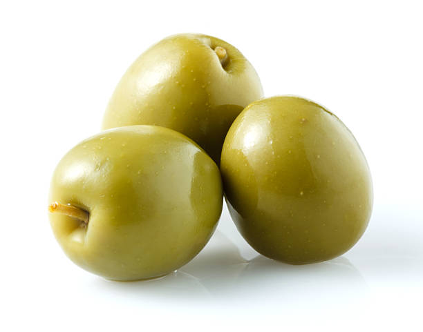 thre green olives isolated on white thre green olives isolated on white green olive fruit stock pictures, royalty-free photos & images