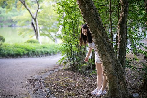Young woman hiding in nature