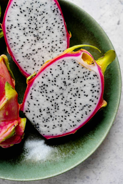 istock Dragon fruit sliced in halves, exotic dragon fruit in a plate 1629342621