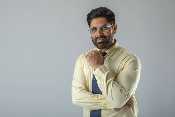 istock Confident businessman with arms crossed over white background 1629345446