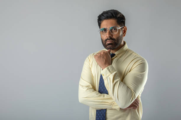 istock Confident businessman with arms crossed over white background 1629346003