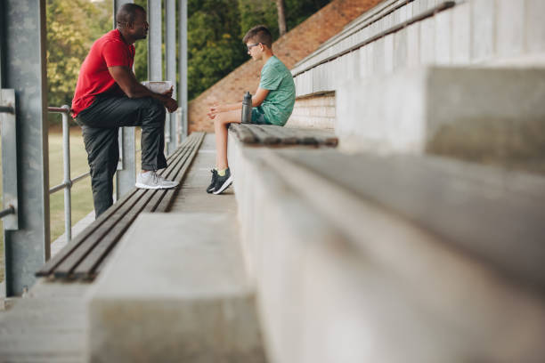 istock Coach motivating a sad school kid outdoors 1629348972