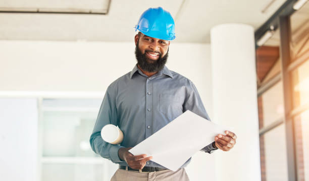 istock Architecture man, portrait and floor plan in office construction, planning and project management. Renovation, property blueprint and happy african person with sketch or design ideas for engineering 1629350171