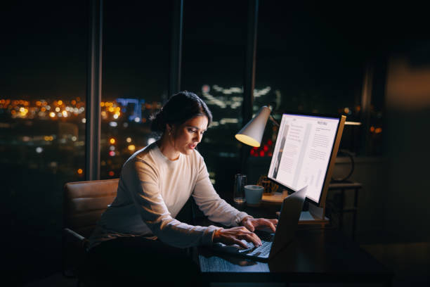 istock Professional woman working late at night on project in office 1629351165
