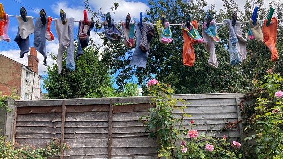 Collection of multi coloured socks on a washing line