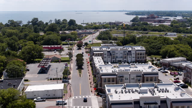 Wealthy Apartment complexes and parking lots along the road in Phoebus, Mill Creek in Hampton, VA. Fort Monroe in the distant. Aerial footage with panning camera motion
