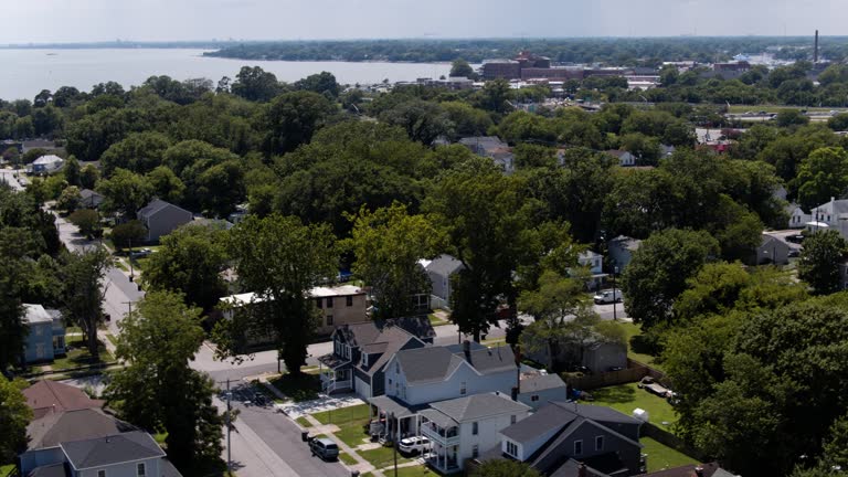 Tree area hide Suburban Neighborhood on the riverside of Phoebus in Hampton, VA. Aerial footage with panning camera motion