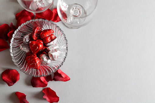 A bowl of chocolate valentine candy sitting on a table