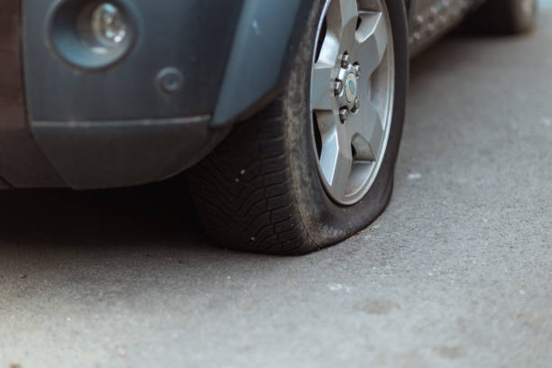 istock Closeup on car with flat tire in city 1629412320