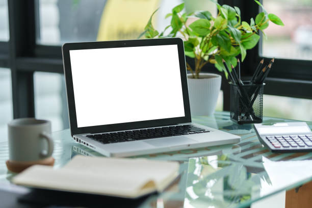 istock Laptop computer with white empty display, calculator and coffee cup on office desk. 1629412796
